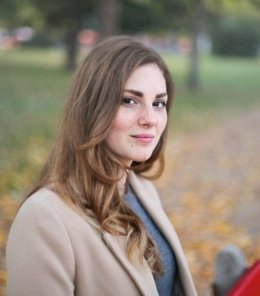 A woman smiles in an autumn setting in Budapest, Hungary.